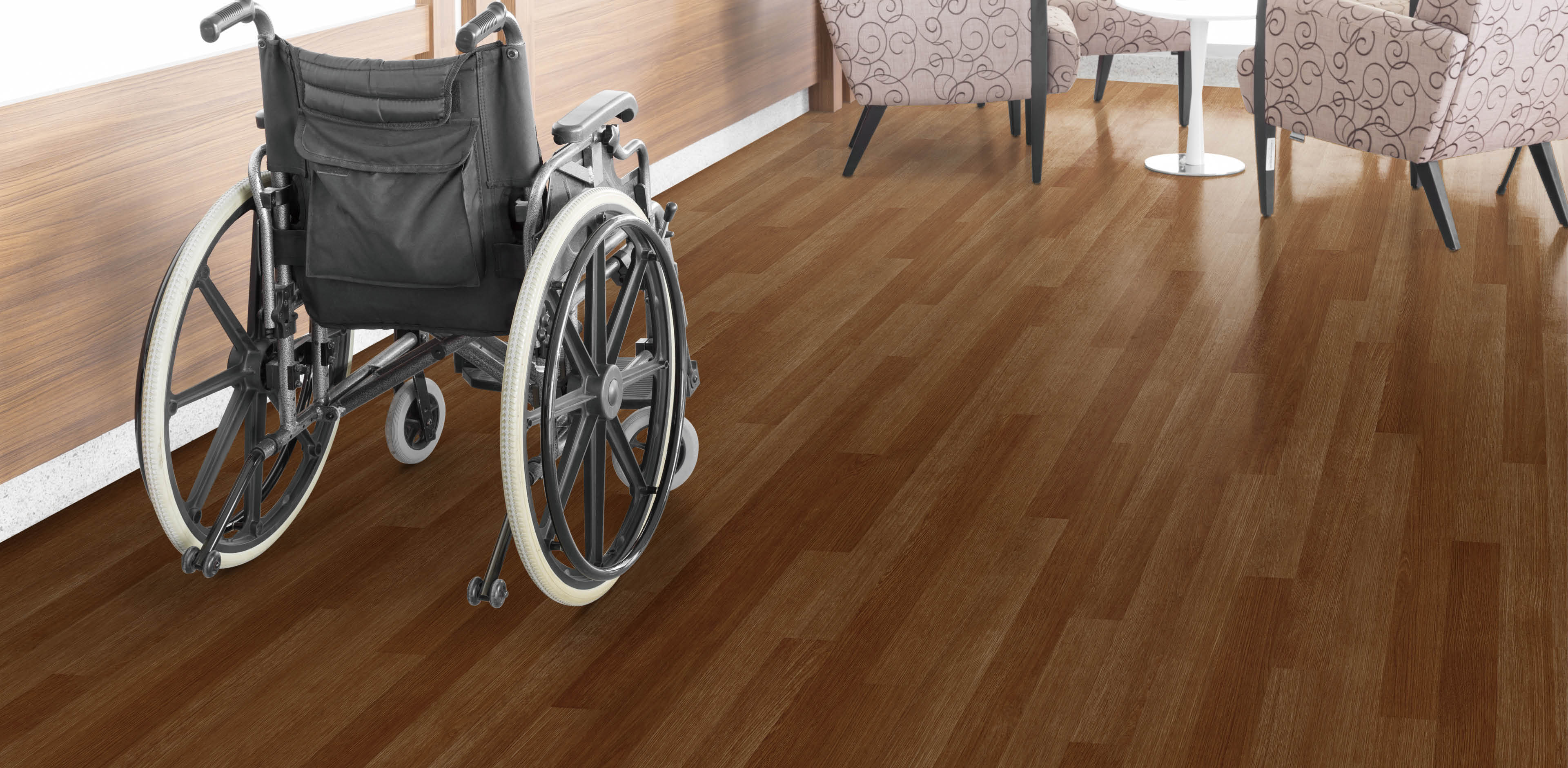 Empty wheelchair parked in hospital hallway