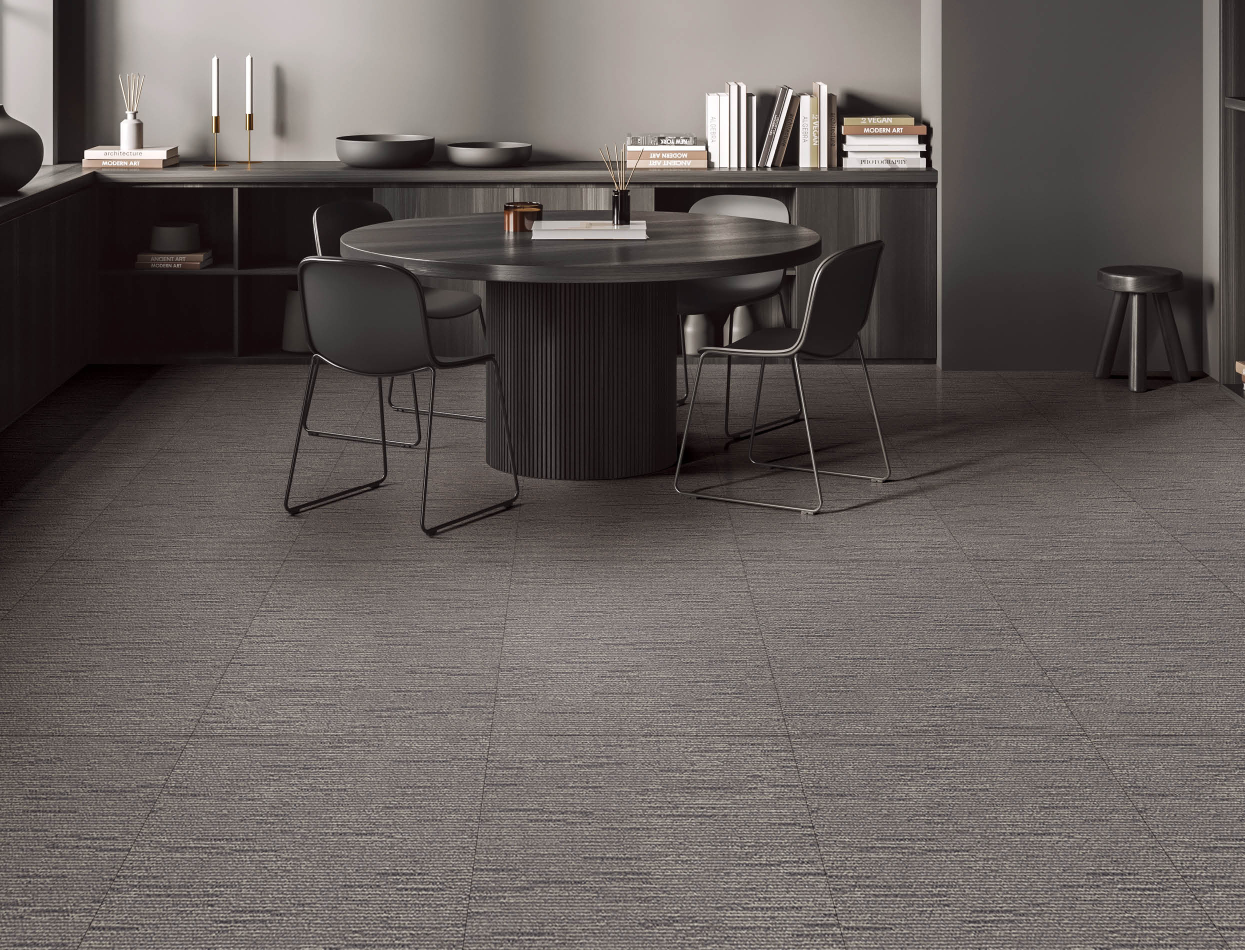 Dark living room interior with dining table and chairs on grey concrete floor. Black wooden drawer with art books and decoration. 3D rendering