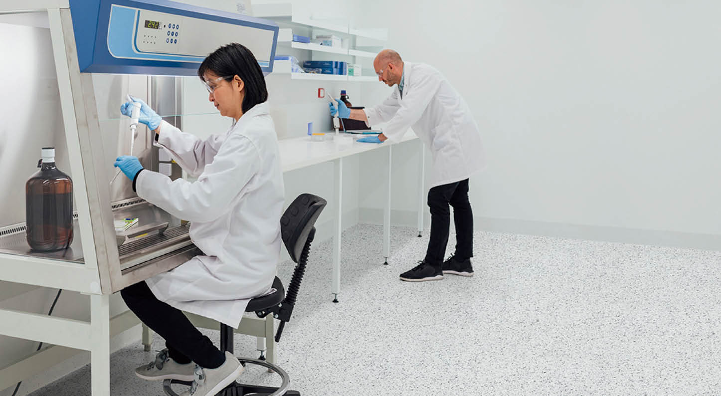 Patient personal health care taken by a specialist biochemist in a research facility being examined by two biochemists 